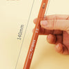 A hand holds an orange micro-pen fineliner with archival ink, demonstrating its size.