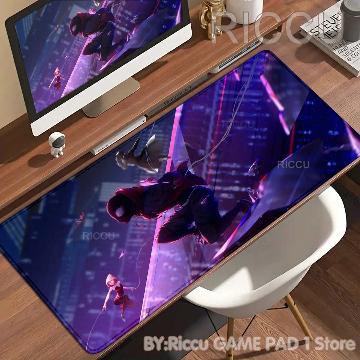 A purple and blue Spider-Man anime desk mat mouse pad displayed on a wooden desk next to a laptop.