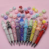 A collection of colorful handmade acrylic flower beads in various shades and sizes arranged on a pink background.