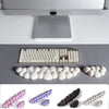 Various ergonomic memory foam wrist rest pads in pink, purple, and beige colors shown from different angles.
