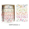 A set of five rolls of floral patterned washi tape for crafting and journaling displayed in a cardboard box.