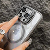 A hand holds a gray MagSafe-compatible phone case featuring a built-in camera bracket and lens cover.