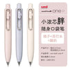 A set of light pink Uni-Ball One P gel pens shown in various angles and with the tip exposed.