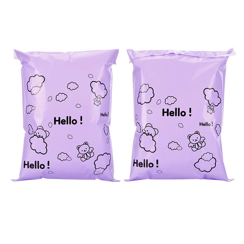 Two purple reusable plastic mailing bags featuring a cloud and bear pattern.