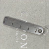 Stainless steel mini ruler keychain marked with centimeters and inches on a gray background.