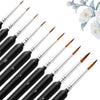 A set of professional miniature paint brushes with black handles and various sizes arranged diagonally.