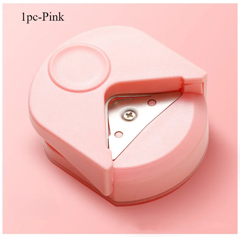 A pink precision corner cutter tool with a hinged design shown from above.
