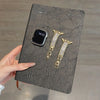 A black leather card features a smartwatch and two gold-toned crystal-embellished watch straps.
