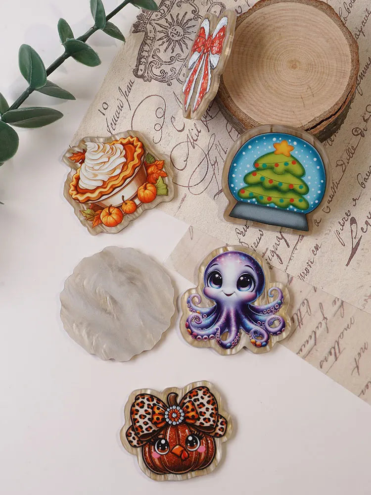 A collection of ten faith-themed acrylic hairbows featuring various designs like a cake, Christmas tree, and octopus.