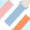 Three adjustable magnetic loop watch bands in pink, blue, and orange colors shown diagonally.