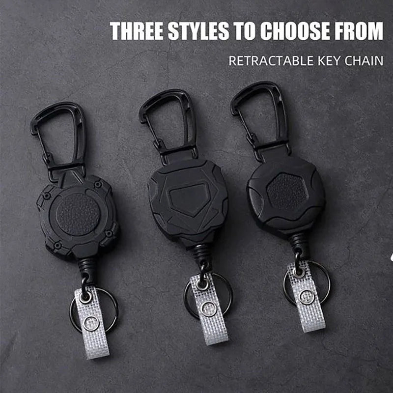 Three styles of black retractable key chains for ID cards and credit cards displayed on a dark surface.