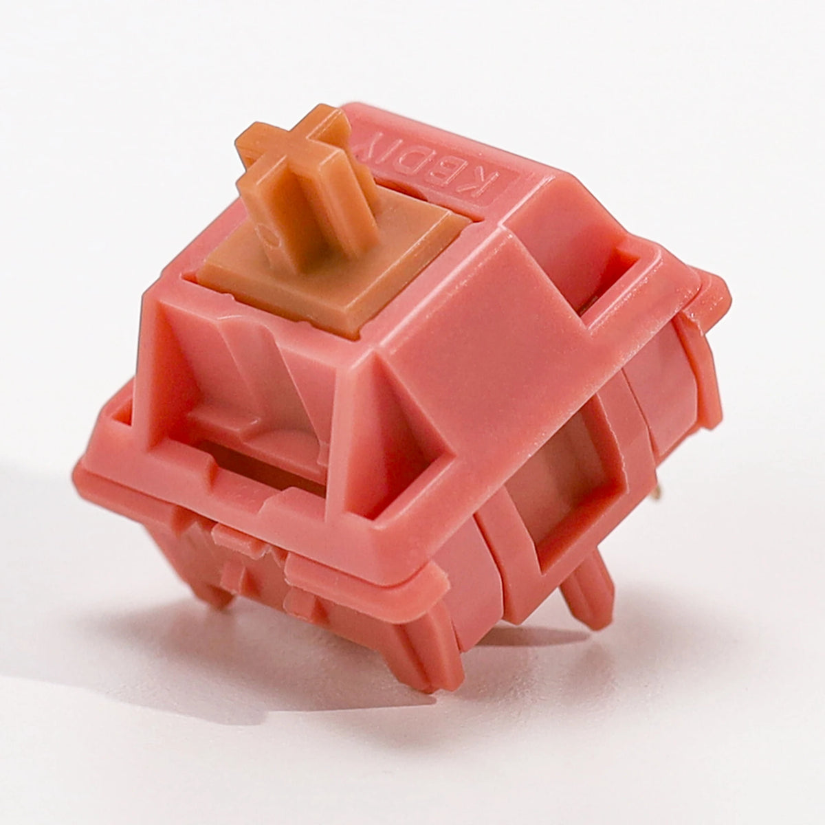 A pink rosewood linear mechanical keyboard switch housing with a square top and visible plastic components.