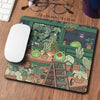 A large desk mat featuring a cute green frog and various plants in a nature-themed design.