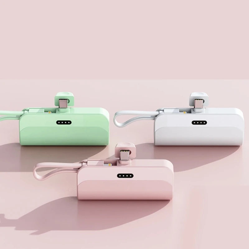 Three portable DIY power bank shells in mint green, white, and pink are displayed on a light surface.