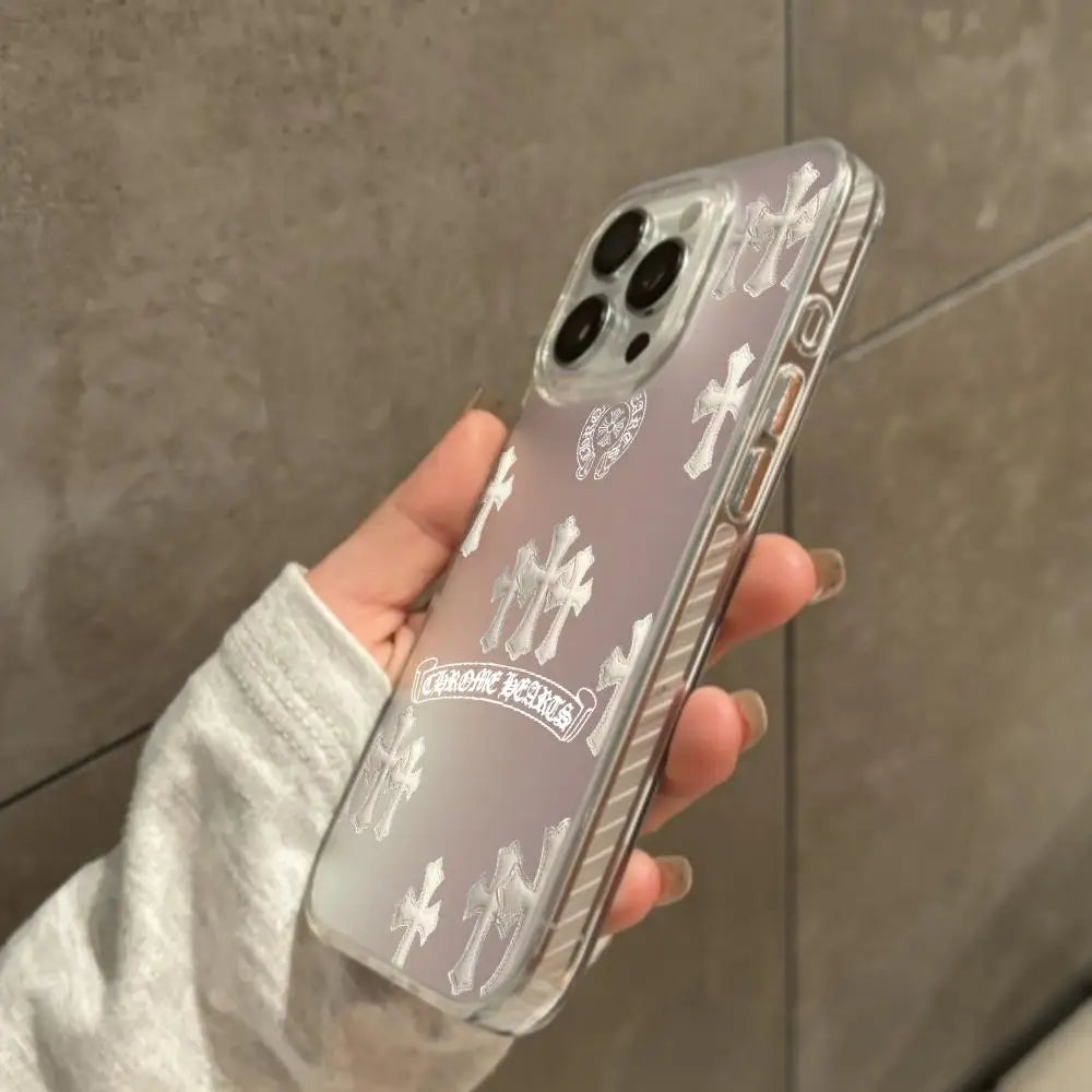 A hand holds a holographic gradient phone case for an iPhone featuring cross designs.