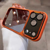 An orange clear shockproof case with multiple camera lenses is held by a hand.