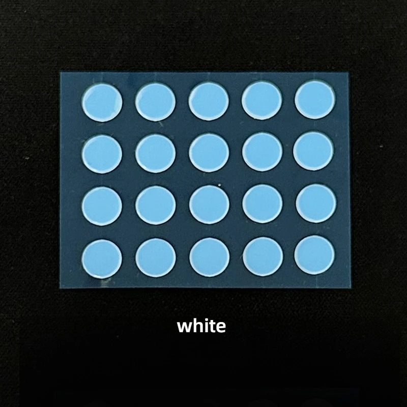 A grid of light blue adhesive dots on a clear plastic surface for PTFE mouse skates.