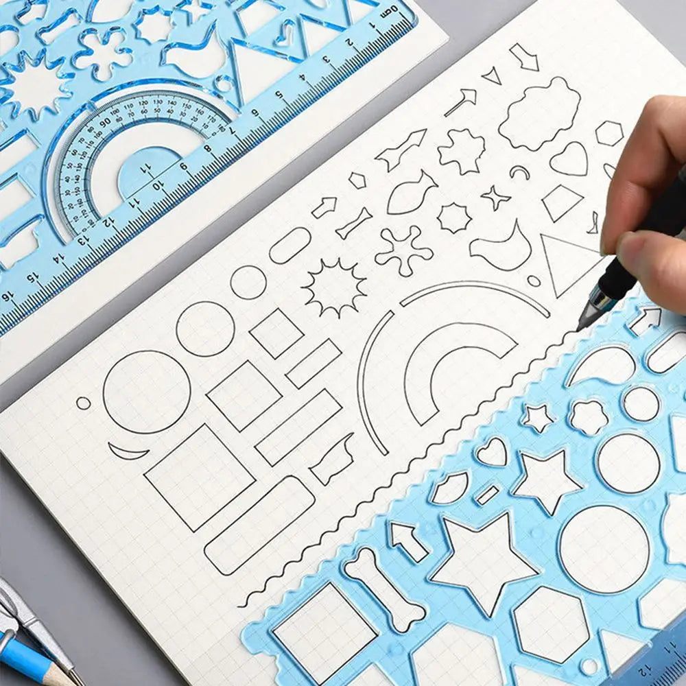 A hand draws geometric shapes and patterns on a spiral notebook using a clear plastic ruler set.
