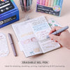 A collection of Qimiart erasable gel pens and a notebook showing an annual plan and expenses.