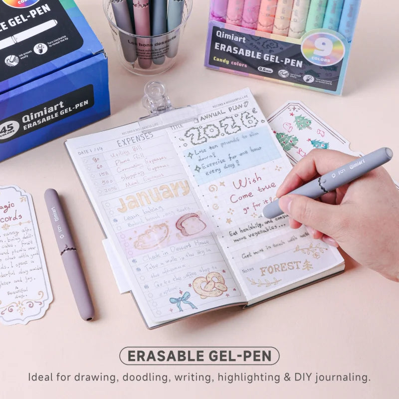 A collection of Qimiart erasable gel pens and a notebook showing an annual plan and expenses.