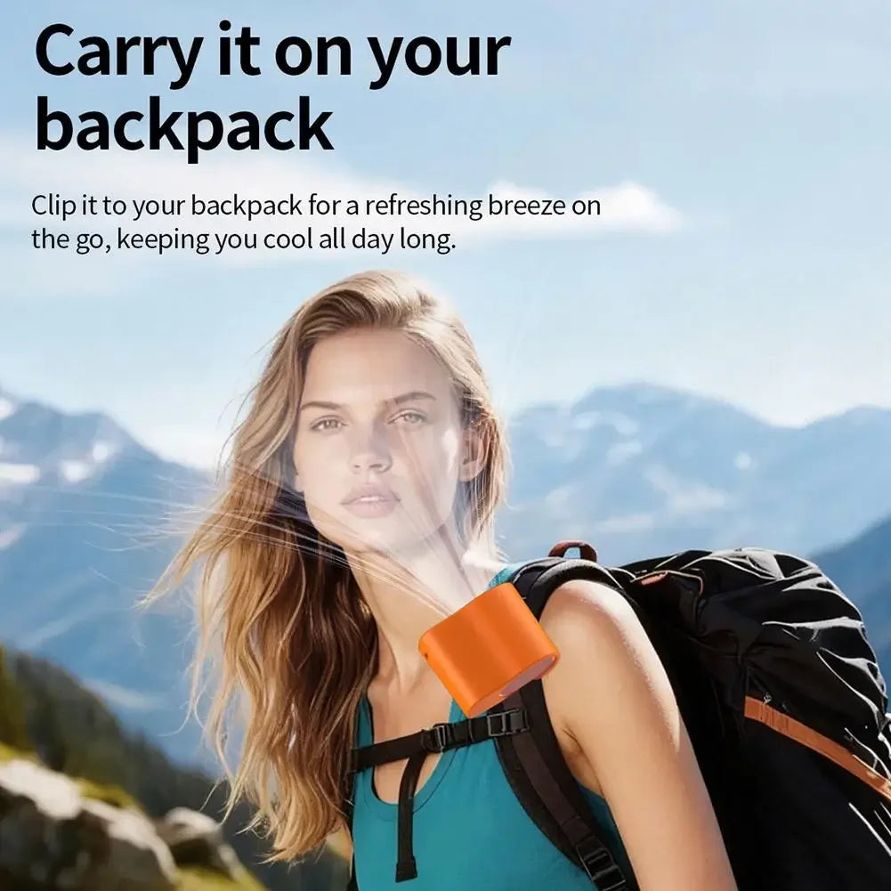 A woman is using a portable clip-on fan on her backpack outdoors in a mountainous landscape.