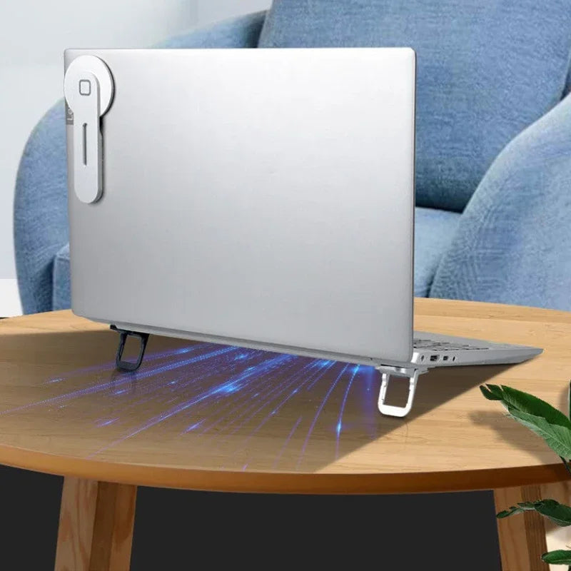 A silver foldable laptop and tablet stand riser resting on a wooden table.