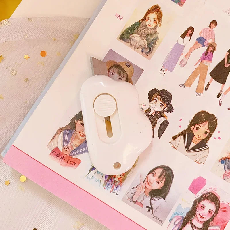 A white adorable cat paw mini cutter is shown next to a page of craft illustrations and stickers.