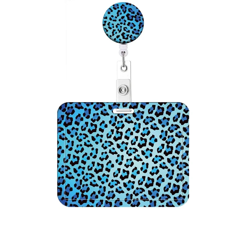 A blue and black leopard print retractable badge holder with a circular clip.