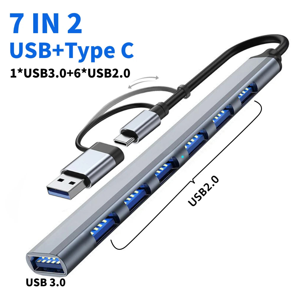 A silver multiport hub featuring seven ports including USB 3.0, USB 2.0, and Type-C connectors.