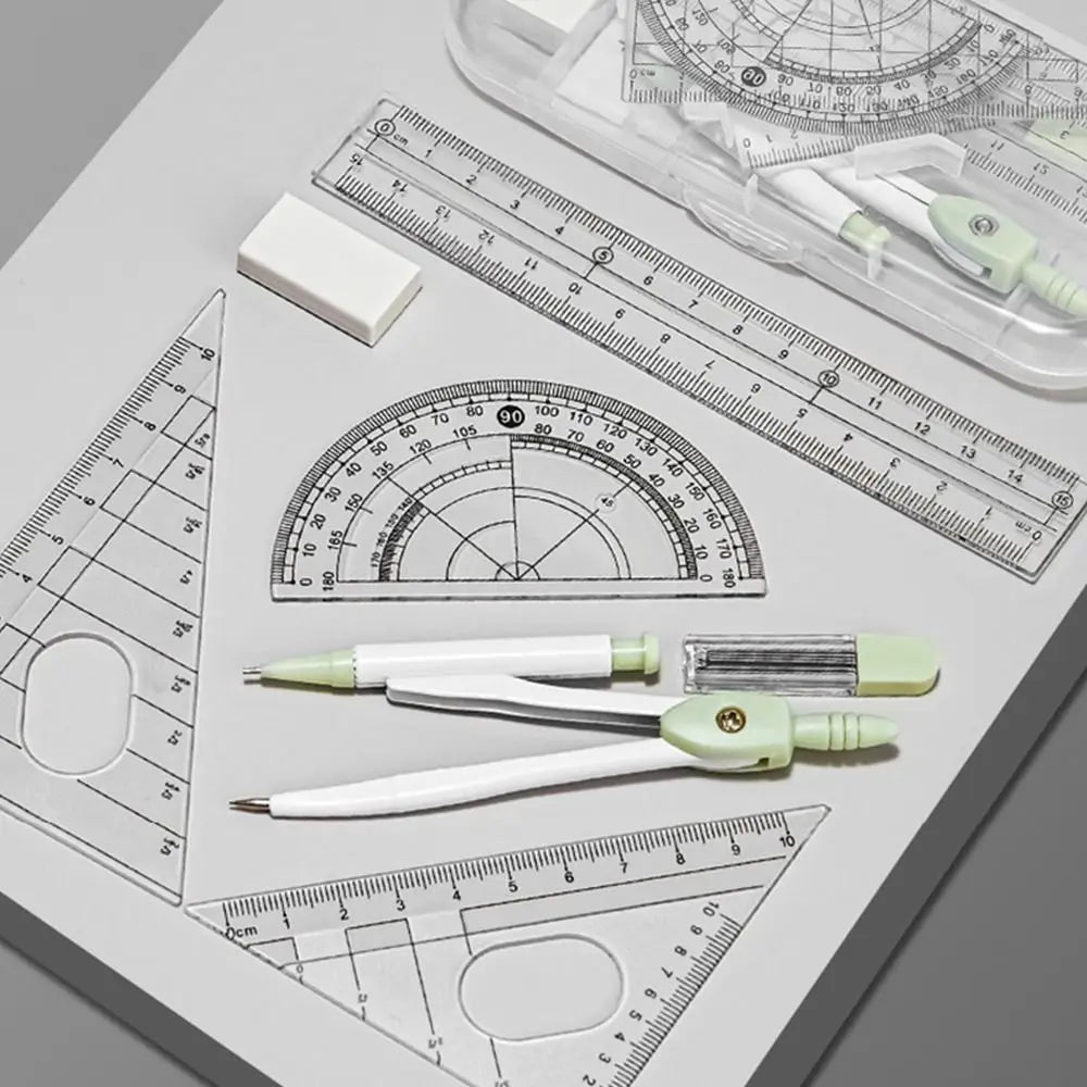 A precision set of transparent measuring tools including rulers, protractors, and calipers laid out on a white surface.