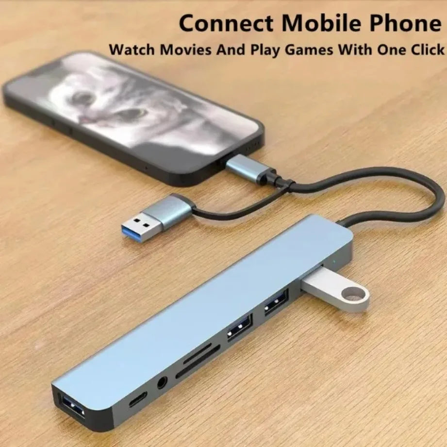 A blue multi-port USB-C hub with a card reader and audio jack connected to a mobile phone cable.