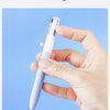 A hand holds a white electronic device with a gentle switch for quiet learning.