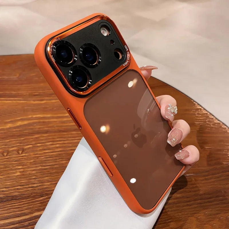 An orange clear shockproof case with camera lens protection for an iPhone is held above a white surface.