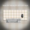 Beige plaid pattern non-slip mouse pad with a black computer mouse and keyboard