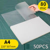 A white thermal laminating pouch is shown next to a clear plastic sheet on a grid background.