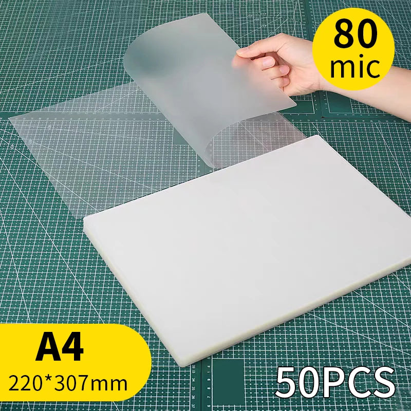 A white thermal laminating pouch is shown next to a clear plastic sheet on a grid background.