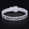 A white precision ring sizer tool with a finger ring and letter markings is shown on a dark surface.