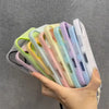 A hand holds a stack of colorful magnetic candy contrast phone cases with lanyards.