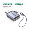 Aluminum grey USB 3.0 to 5Gbps adapter with a lanyard attached