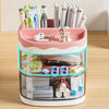 A pink desktop pen holder with a clear top section displaying various pens, pencils, and stationery items.