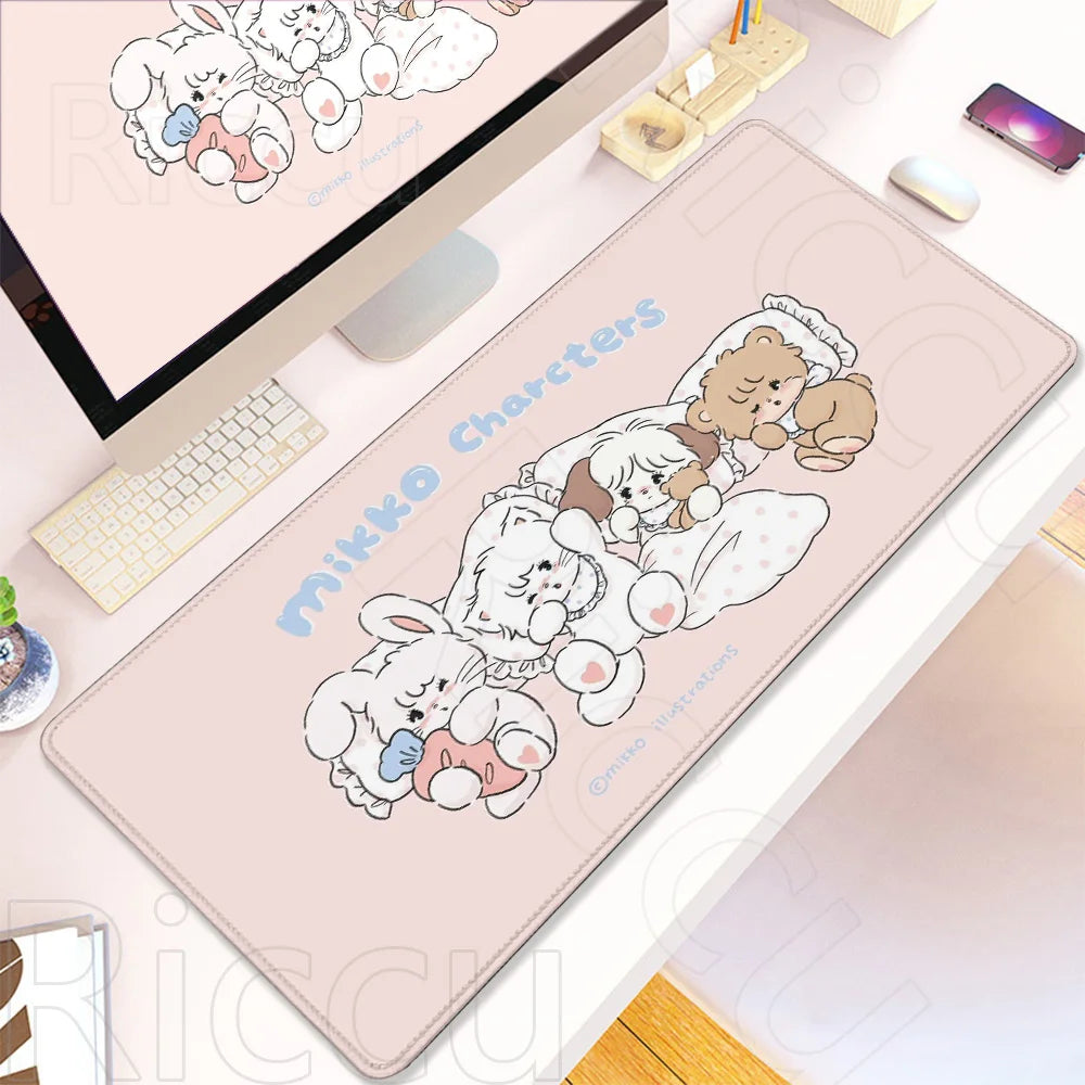 A pink cartoon gaming desk mat featuring a group of fluffy white and brown rabbits.