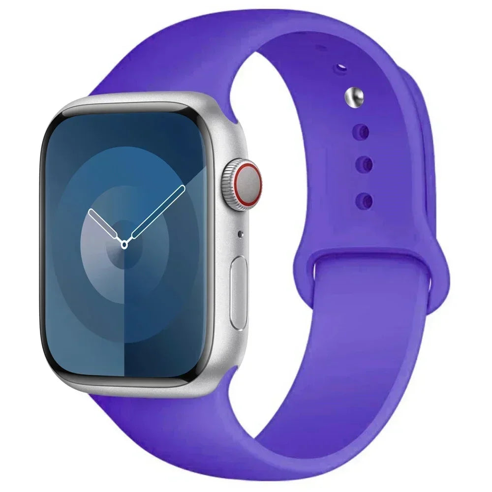 A silver Apple Watch is shown with a purple silicone sport band.