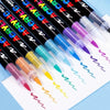 A collection of black acrylic paint markers in various bright colors, laid out on white paper.