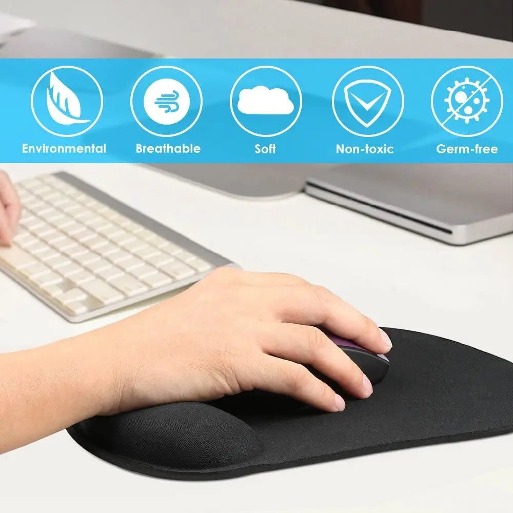A hand rests on a black ergonomic mouse pad with wrist support, next to a laptop.