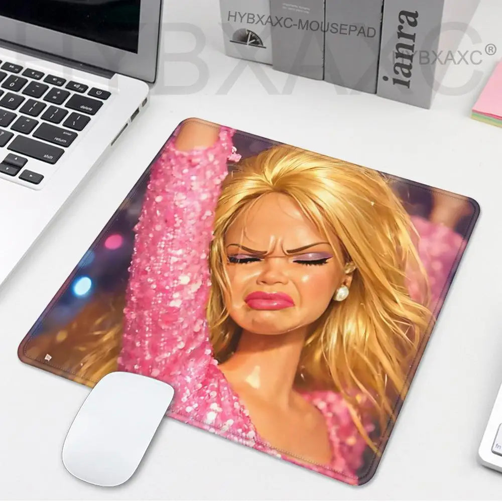 A glossy pink and gold playful doll face mouse pad featuring a blonde woman's portrait.