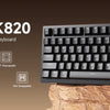 A black AJAZZ AK820 75% wired mechanical keyboard shown on a wooden surface.