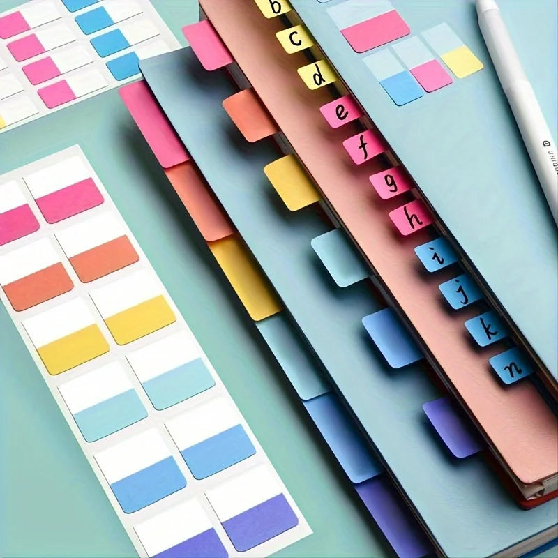A close-up of colorful index tags and labels arranged in a grid on a light blue surface.