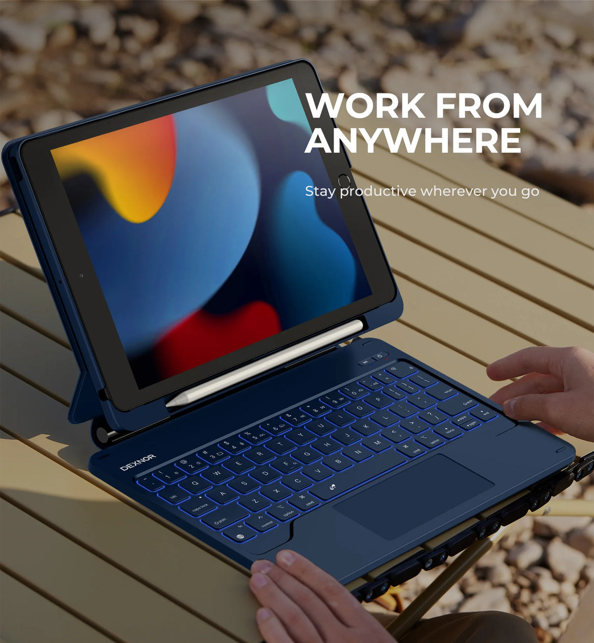A blue Dexnor laptop is shown with a magnetic keyboard case, positioned on a wooden surface, emphasizing work from anywhere.