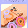 Various colored magnetic ring grips and foldable kickstands for MagSafe phones displayed on an orange phone.