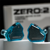 A pair of blue transparent in-ear monitors labeled ZERO:2 resting on a white surface.